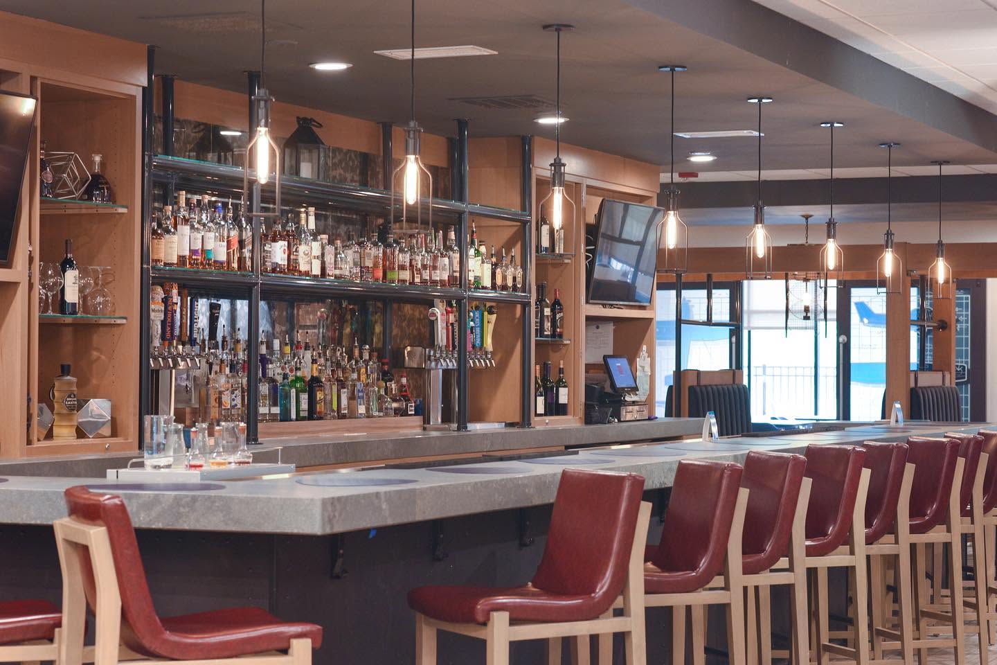 Large stocked bar with red bar stools