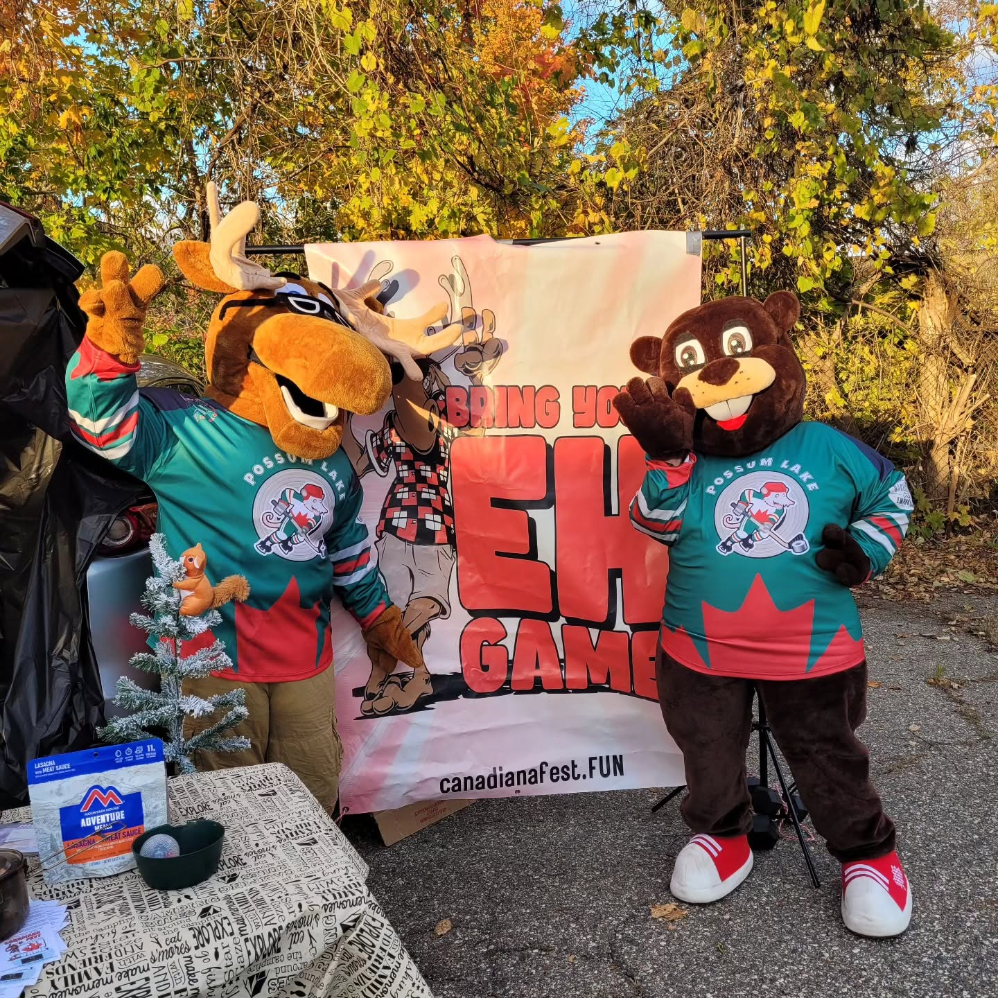 Photo of a moose and beaver mascot waving